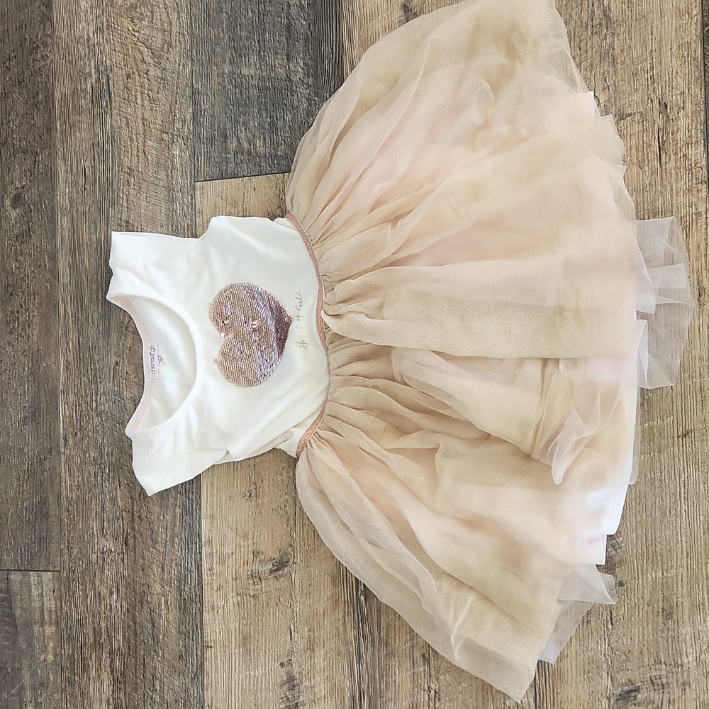 Cream and Tan Kids Dress with a hart design.